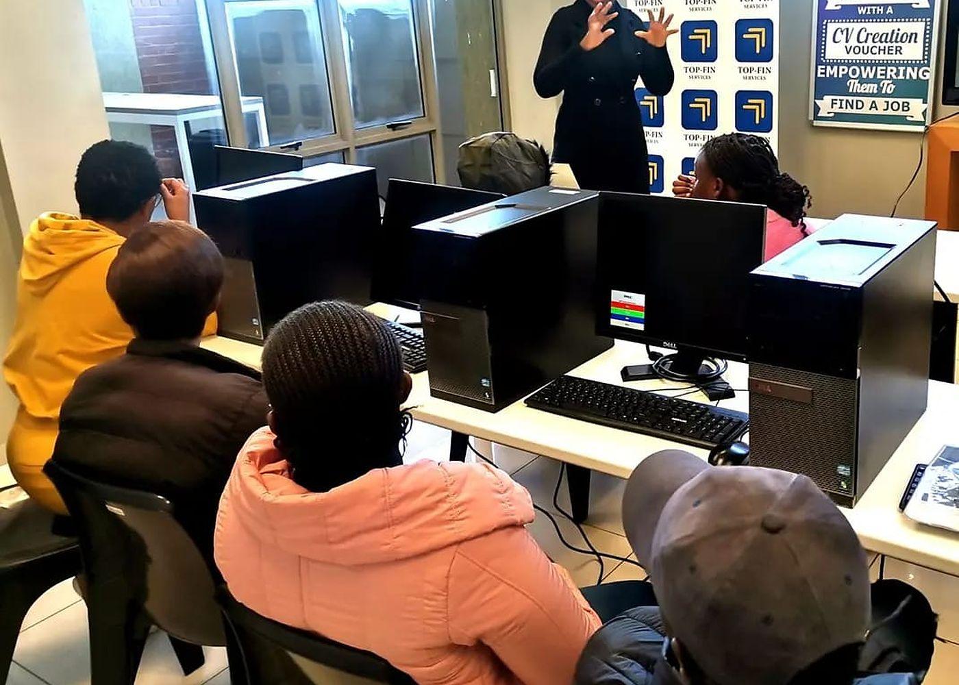 Participants working through a Top-Fin session in a computer training room